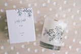honeysuckle jasmine soy candle with floral illustration on the glass with a crackling wooden wick and a blush gift box on polka dot background